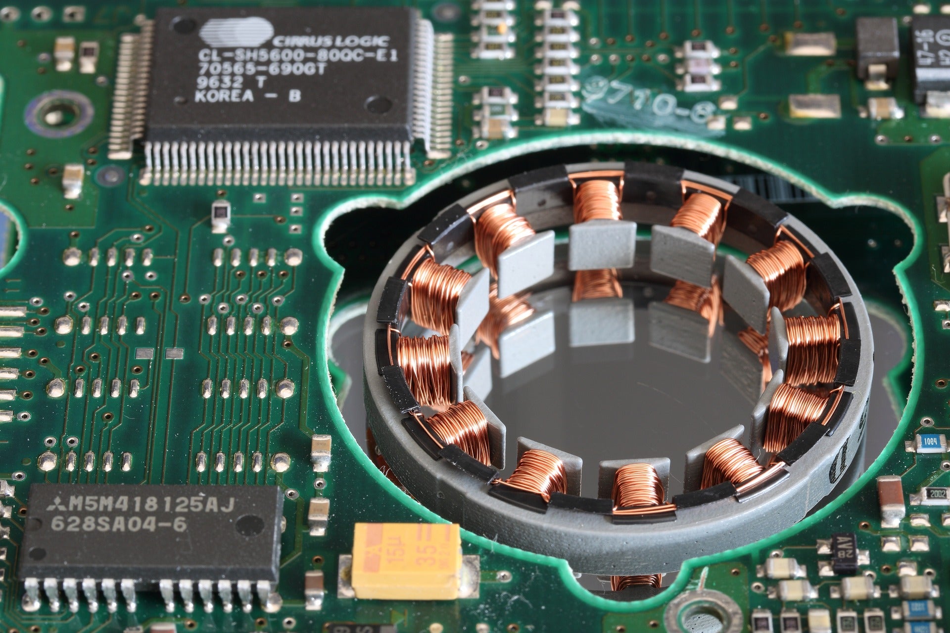 A coil of copper wire on a motherboard, arranged in circular fashion.